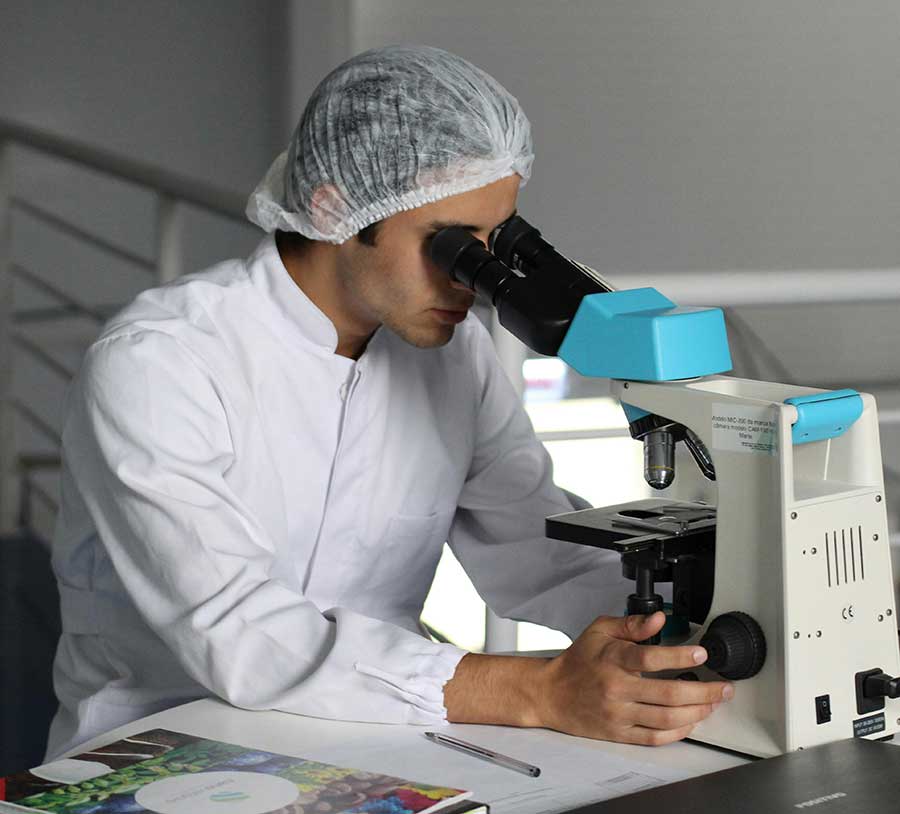 Scientist Looking Through Magnifying Device